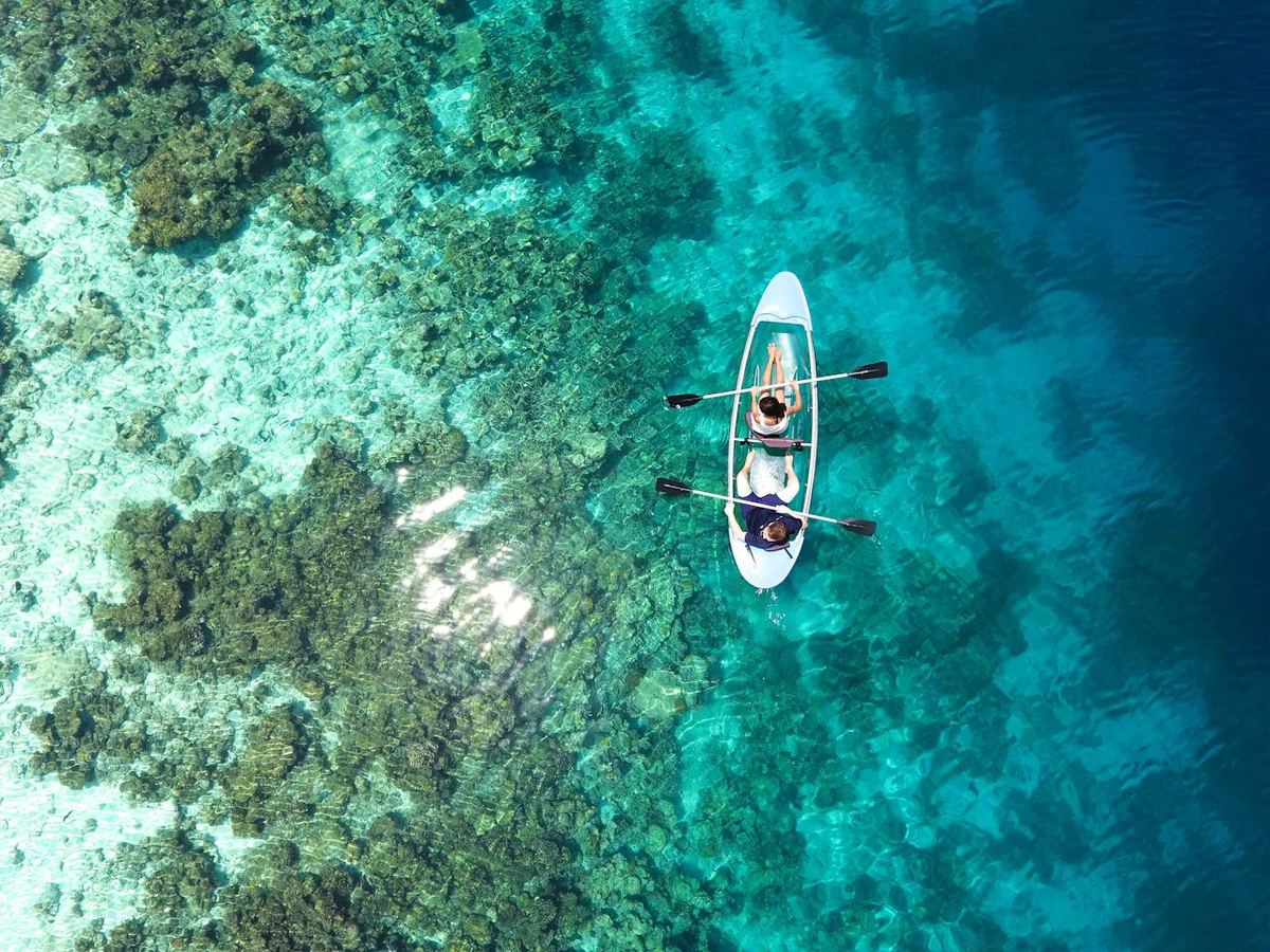 Kayaking through clear turquoise waters near tropical islands